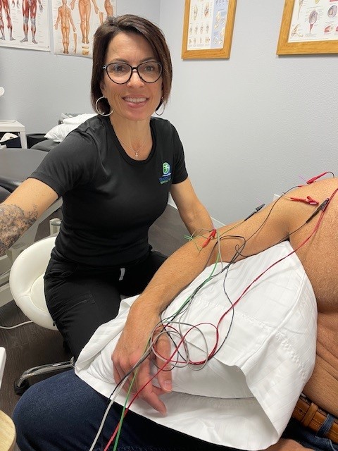 image show Dr Dana administering dry needling on a male patents upper arm
