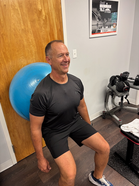 Images shows squats with an excercise ball