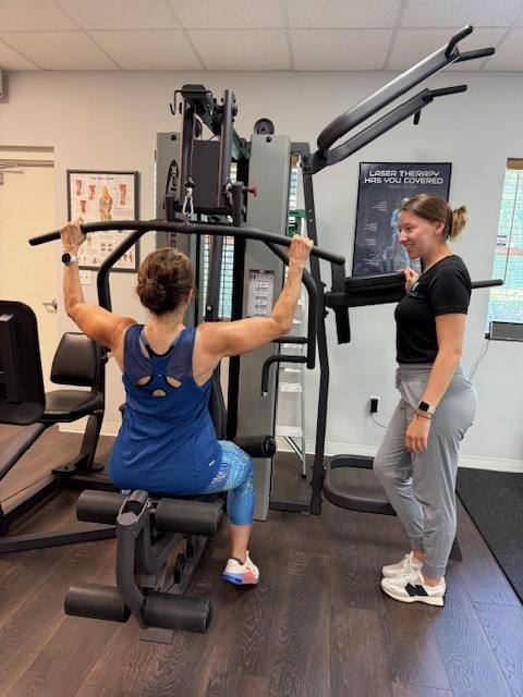 Image shows person using strenght building equipment