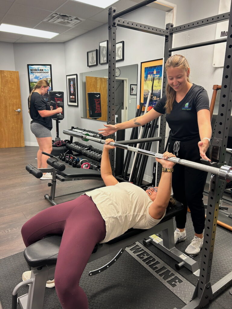Image shows training using a free weights on a bench