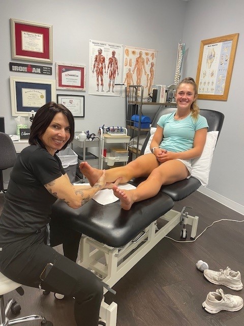 person having there ankle worked on by physio therapist